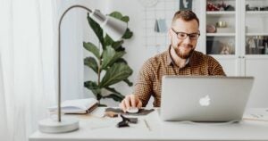 Accountant working on his laptop in a home office space.